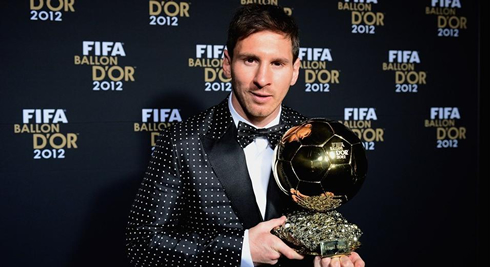 Lionel Messi holding the new FIFA Balon d'Or 2012 award