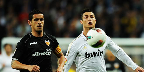 Cristiano Ronaldo running side by side with Ricardo Costa, in Real Madrid vs Valencia