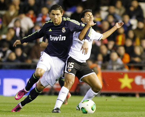 Cristiano Ronaldo putting his arm around the defender, in order to gain advantage and a better position