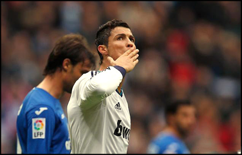 Cristiano Ronaldo sending kisses to his son and mother, after scoring a goal for Real Madrid in 2013