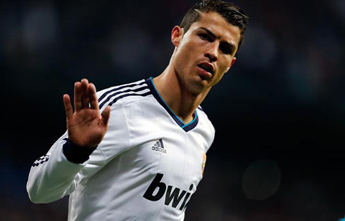Cristiano Ronaldo be calm and quiet celebration, with his hand gesture moving up and down, in Real Madrid 2013