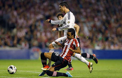 Cristiano Ronaldo getting hit and tackled by a defender from Athletic bilbao, in a game for Real Madrid in 2013