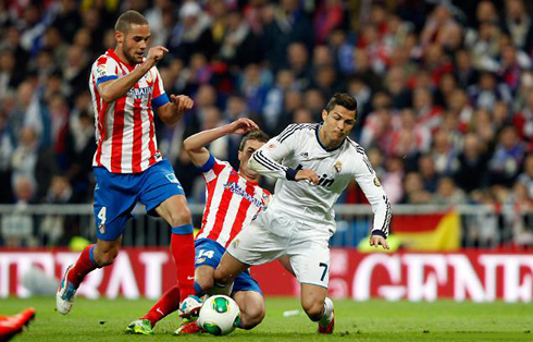 Cristiano Ronaldo being tackled in Real Madrid vs Atletico Madrid, for the Copa del Rey final, in 2013