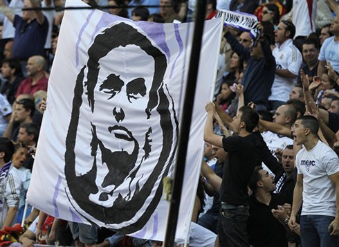 Real Madrid fans holding a Mourinho face banner, in the Santiago Bernabéu stands
