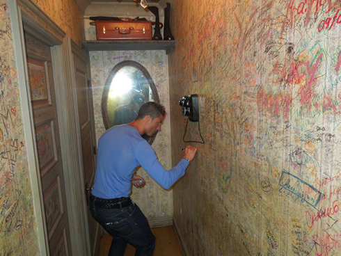 Cristiano Ronaldo signing his name on a holocaust wall in New York City