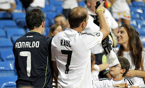 Two Real Madrid fans showcasing the clash of two generations wearing the number 7 jersey or Cristiano Ronaldo and Raúl