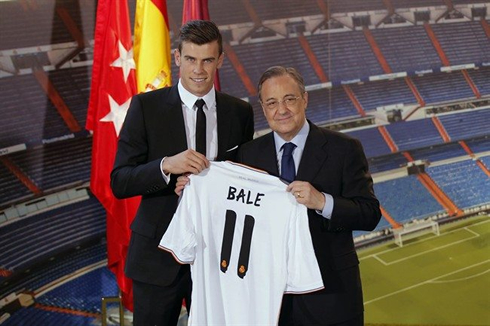 Gareth Bale holding his new jersey number 11 for Real Madrid
