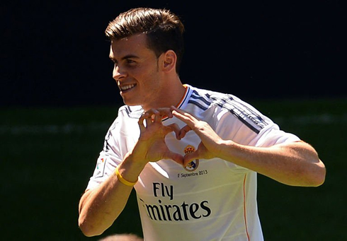 Gareth Bale trademark gesture, making a heart symbol in front of his chest, with a Real Madrid jersey