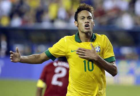 Neymar clapping with his hand on his chest, while playing for Brazil