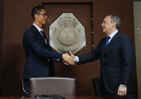 Cristiano Ronaldo sealing the deal for his contract extension, handshaking Florentino Pérez