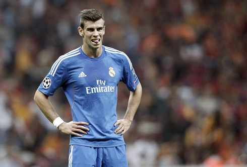 Gareth Bale with his hands on his waist, in Real Madrid 2013-2014 blue jersey uniform and kit