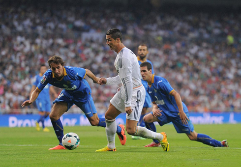Cristiano Ronaldo dribbling two defenders and leaving them on the ground