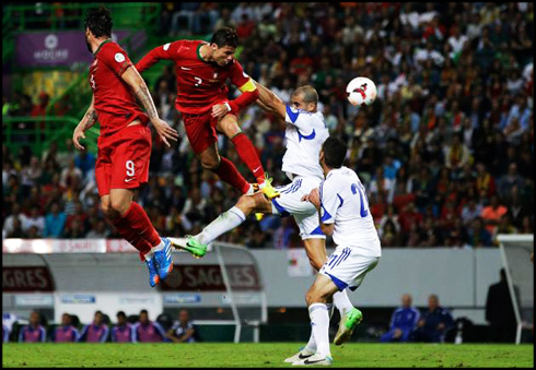Cristiano Ronaldo jumping high in the air and heading the ball