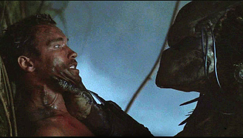 Arnold Schwarzenegger face to face with the alien in predator