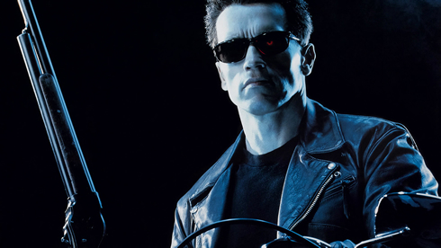 Arnold Schwarzenegger, wearing black sunglasses, riding a motorbike and with a shotgun, the terminator