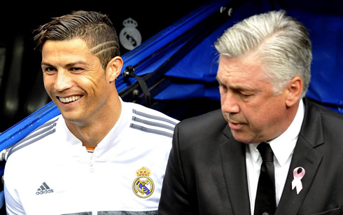 Cristiano Ronaldo smiling next to Carlo Ancelotti