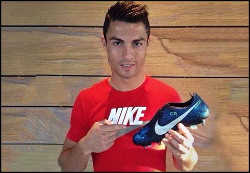 Cristiano Ronaldo holding the new Nike football boots, the CR7 Mercurial Vapor IX Galaxy
