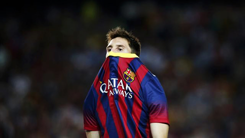 Lionel Messi hiding his face behind Barcelona's new jersey for 2013-2014