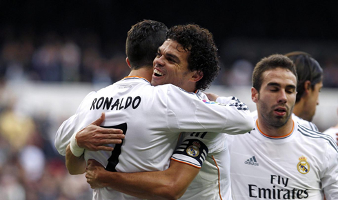 Cristiano Ronaldo strong hug to Pepe, who has a head full of hair