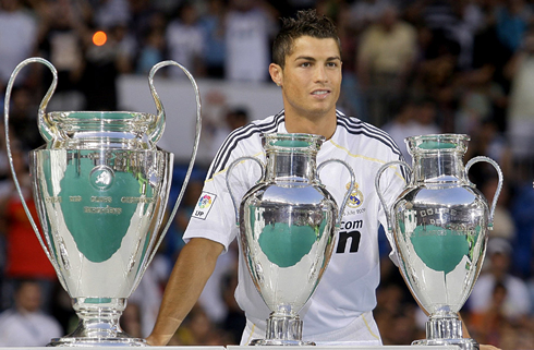 Cristiano Ronaldo staring at Real Madrid UEFA Champions League trophies