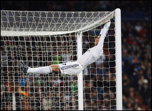 Cristiano Ronaldo hanging on the crossbar