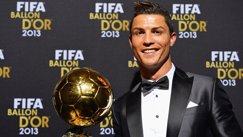 Cristiano Ronaldo happy and smiling with the FIFA Ballon d'Or 2013 trophy