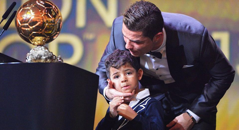 Cristiano Ronaldo showing the FIFA Ballon d'Or 2013 trophy to his son, Cristiano Jr