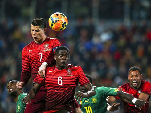 Cristiano Ronaldo jumping over William Carvalho, in Portugal vs Cameroon