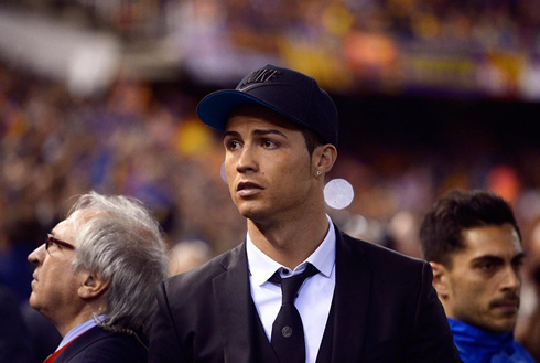 Cristiano Ronaldo wearing a suit and a Nike hat