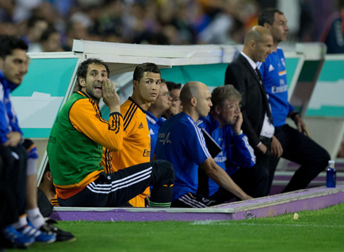 Cristiano Ronaldo looking to the pitch from the Real Madrid bench