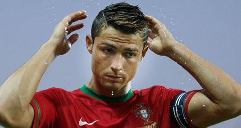 Cristiano Ronaldo combing his hair during game for Portugal