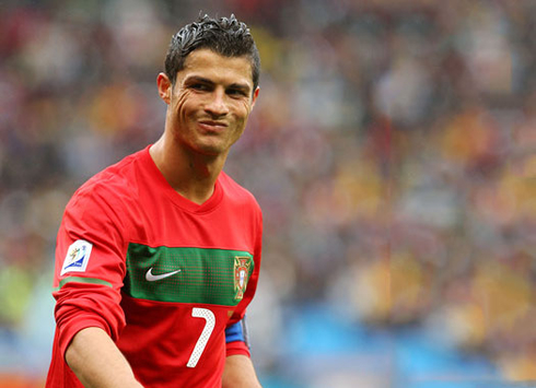 Cristiano Ronaldo making an enigmatic face while playing with a Portugal jersey