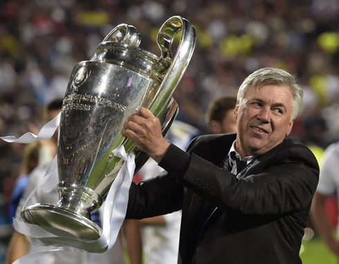 Carlo Ancelotti holding the Champions League trophy he won for Real Madrid in 2014