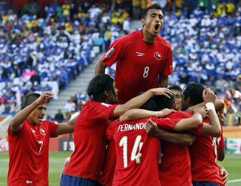 The Chile National Team players piling after scoring a goal
