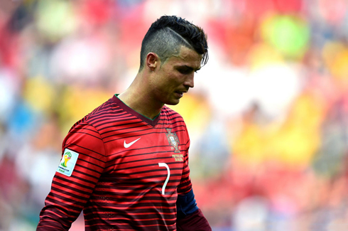 Cristiano Ronaldo with his head down, after Portugal's elimination of the 2014 FIFA World Cup