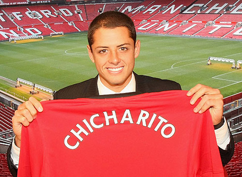 Chicharito holding his Manchester United jersey, after signing for the club in 2010