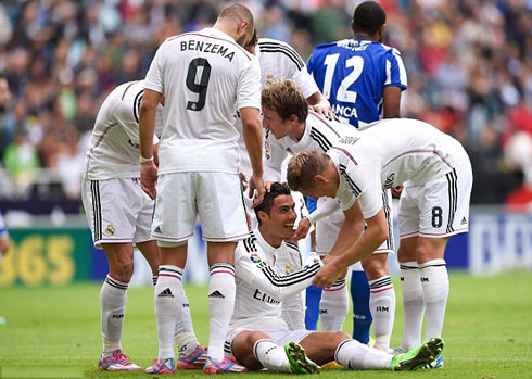 Cristiano Ronaldo being helped to stand up, after scoring a goal for Real Madrid