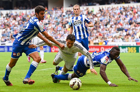 Cristiano Ronaldo falling to the ground after clashing against a defender