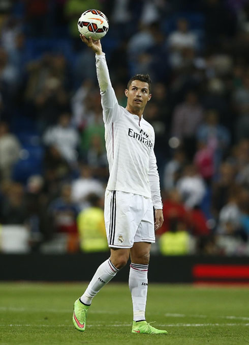 Cristiano Ronaldo holding the poker match ball in the air, before he takes it home to his museum