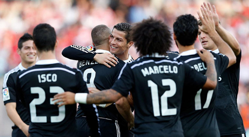 Real Madrid players surrounding Cristiano Ronaldo after his first goal against Granada