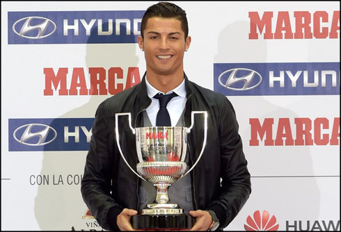 Cristiano Ronaldo holding the MARCA Pichichi award trophy for becoming the top scorer in La Liga