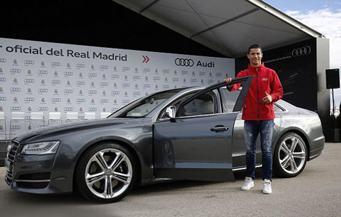 Cristiano Ronaldo standing in front of his new Audi S8