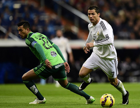 Cristiano Ronaldo dribbling a Celta de Vigo defender, in a Spanish League game