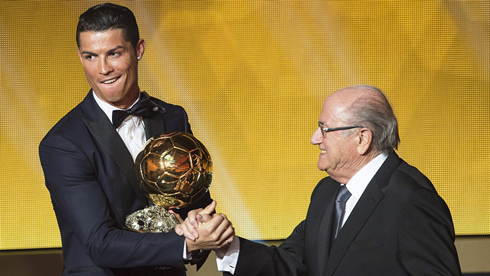 Cristiano Ronaldo looking away as he greets Joseph Blatter