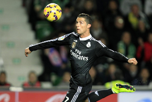 Cristiano Ronaldo focusing on the ball trajectory to hit a clean strike