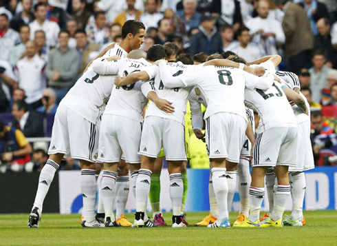 Real Madrid players gathering around to motivate themselves before a Champions League match
