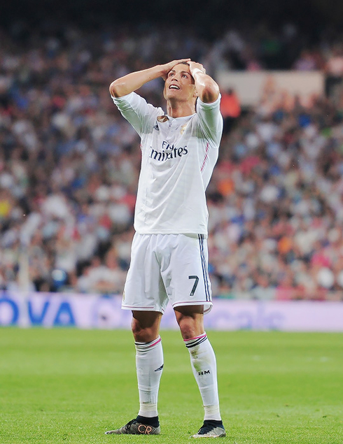 Cristiano Ronaldo grabbing his head and hair in despair