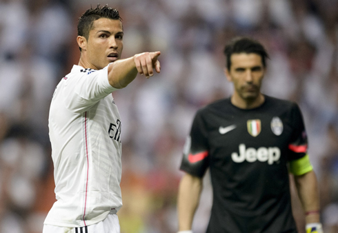 Cristiano Ronaldo pointing with his finger while Buffon watches behind him