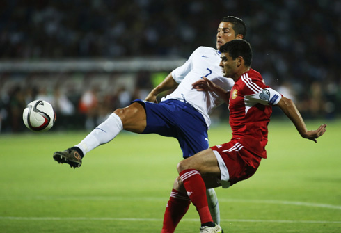 Cristiano Ronaldo lobbing the ball above Armenia's goalkeeper head