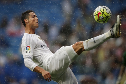 Cristiano Ronaldo stretching his right leg to control a ball